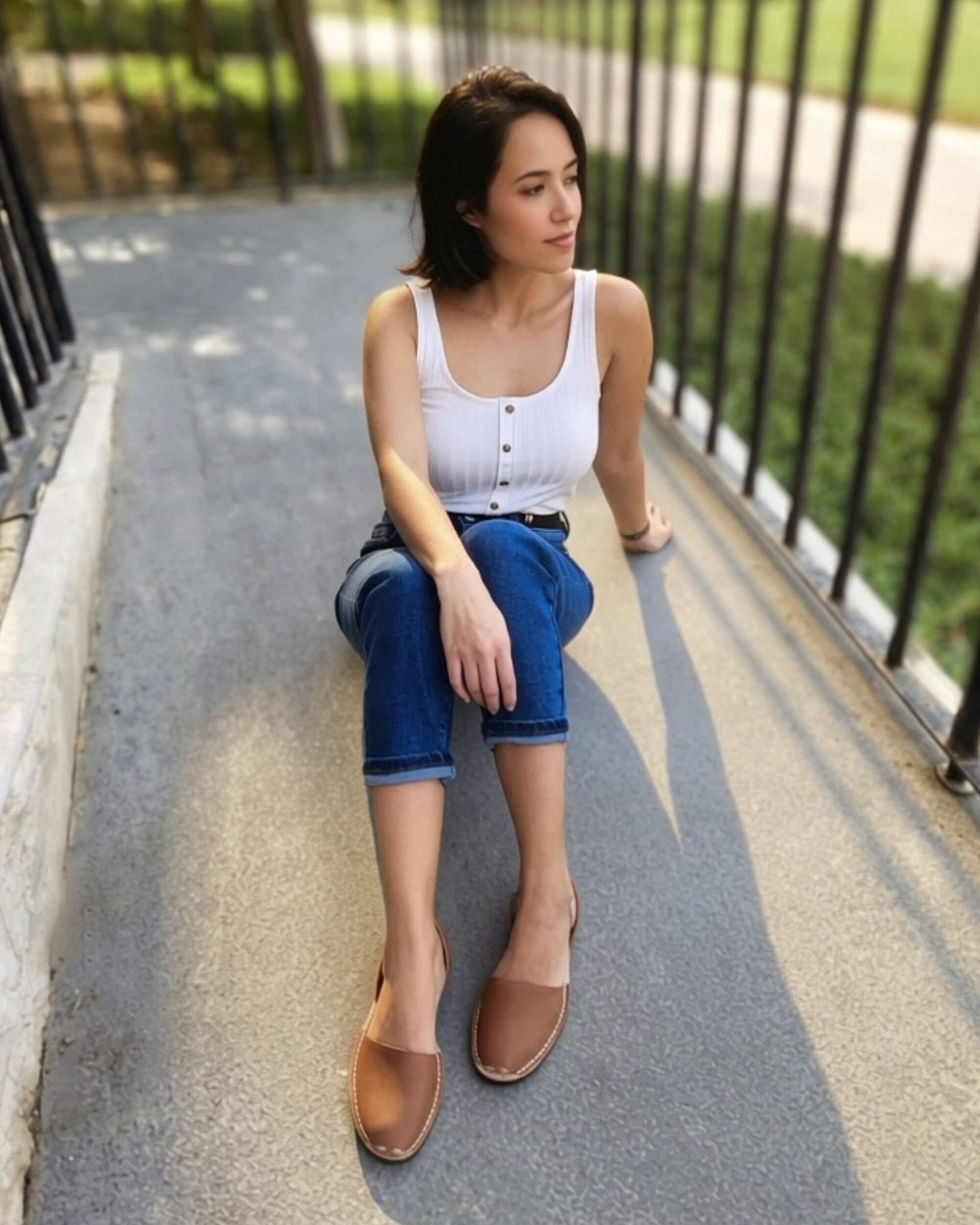 Woman wearing chocolate brown Classic Avarca with jeans Dubai style
