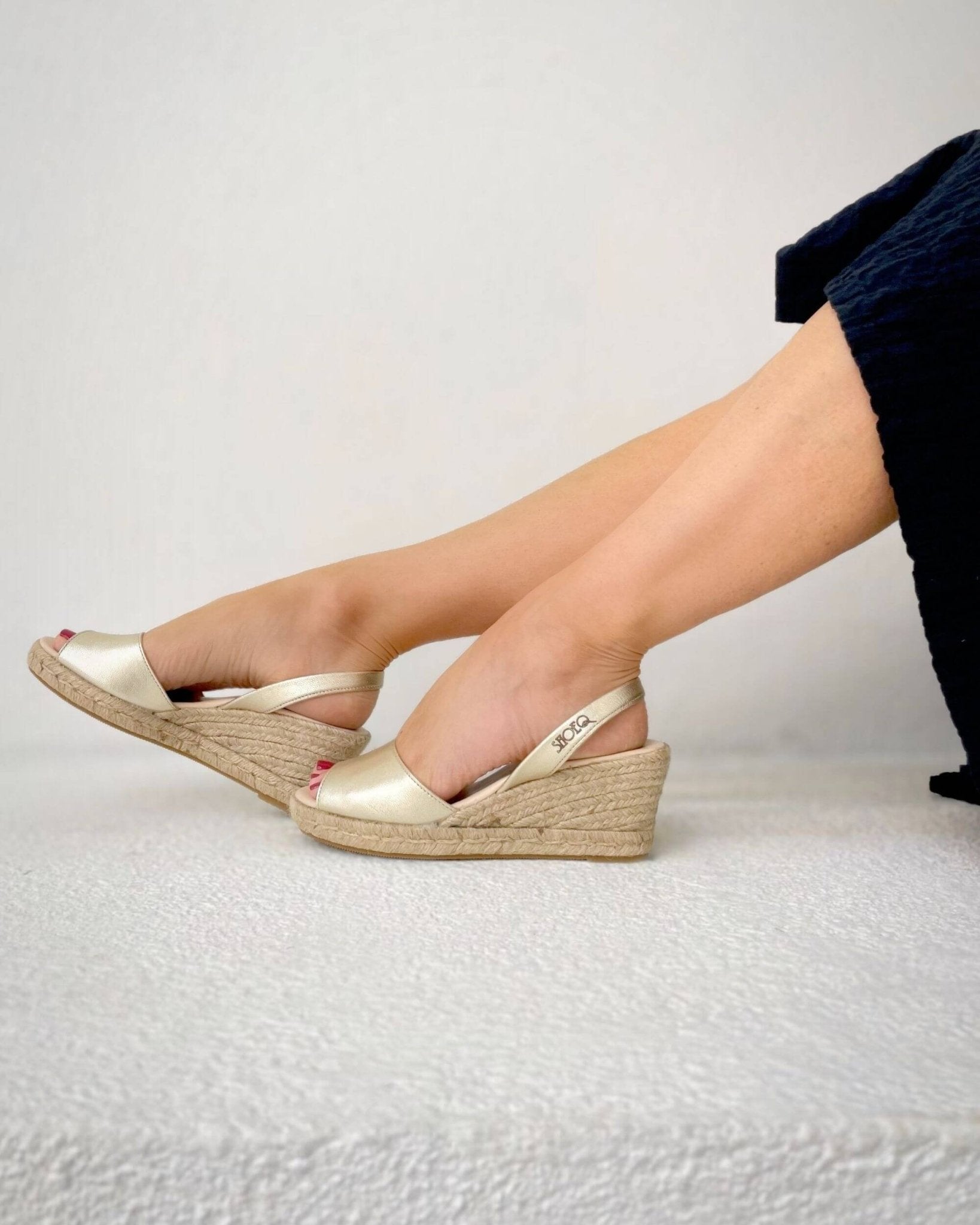 Classic espadrille wedge champagne on model walking Dubai
