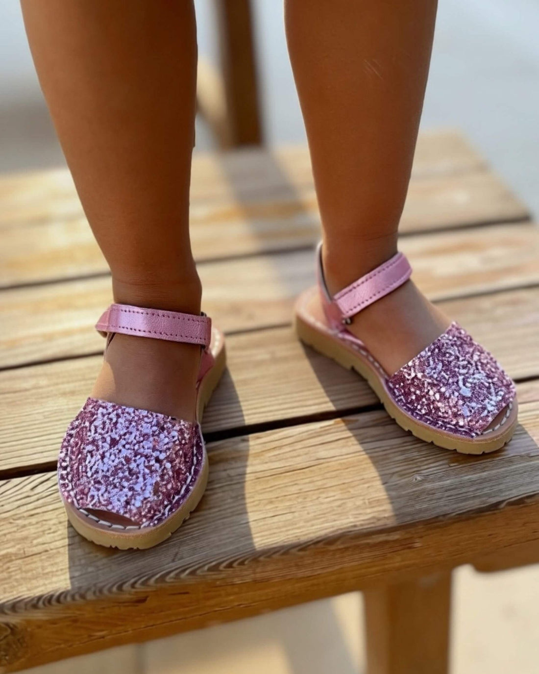 Pink glitter kids leather sandals with a buckled ankle strap, handmade in Menorca, Spain | Girls Ankle Strap Avarca by Shoeq