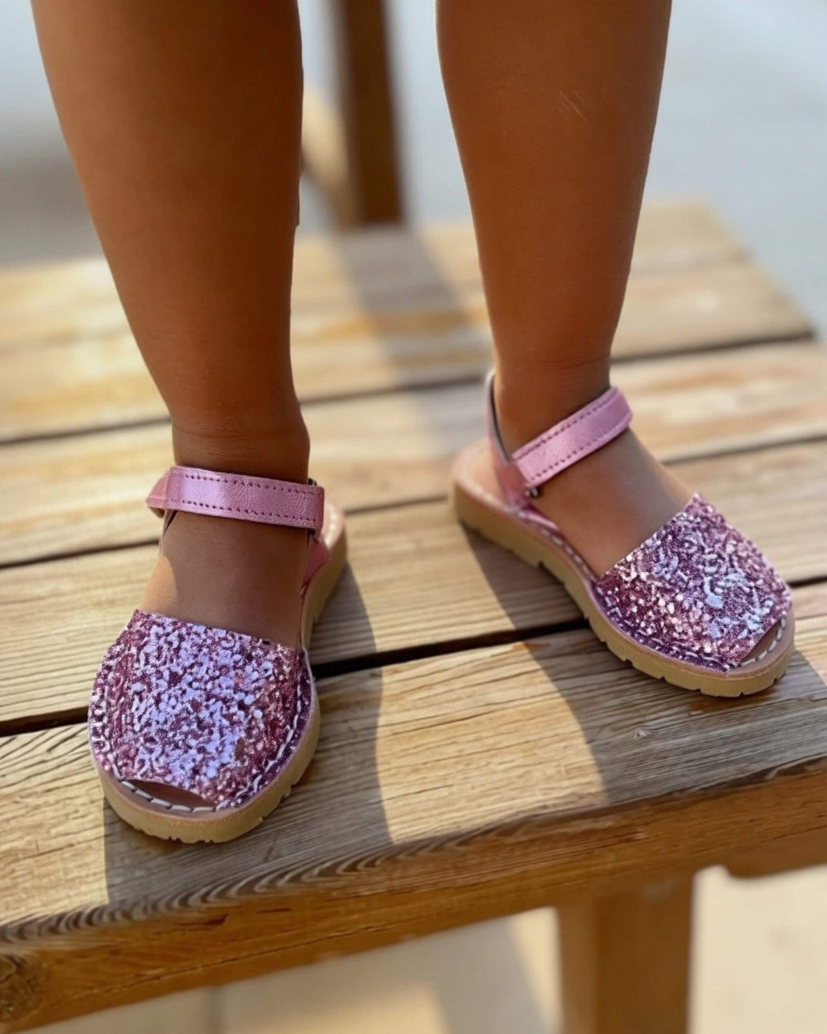 Pink glitter kids leather sandals with a buckled ankle strap, handmade in Menorca, Spain | Girls Ankle Strap Avarca by Shoeq
