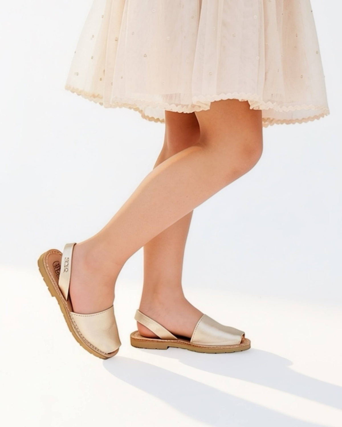 Champagne gold kids leather sandals side view showing a secure strap | Girls Classic Avarca by Shoeq