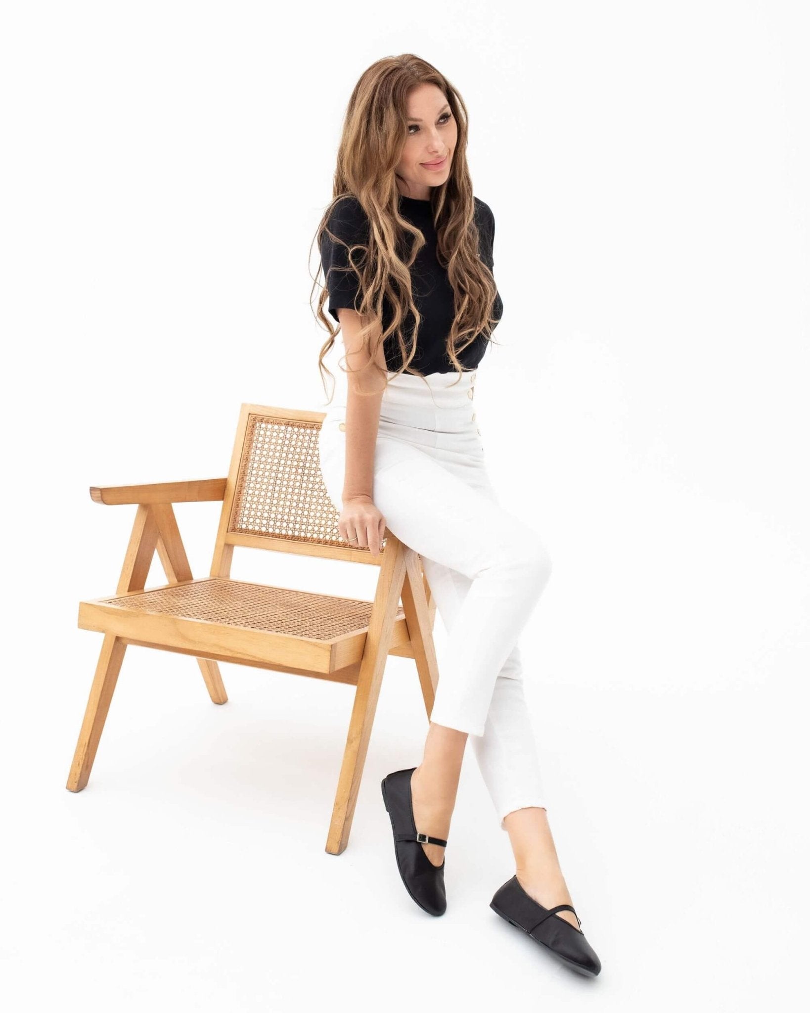 Handmade black nappa leather Mary Jane flat with closed toe and heel, ankle strap, styled with white trousers | Mary Jane in Midnight by Shoeq