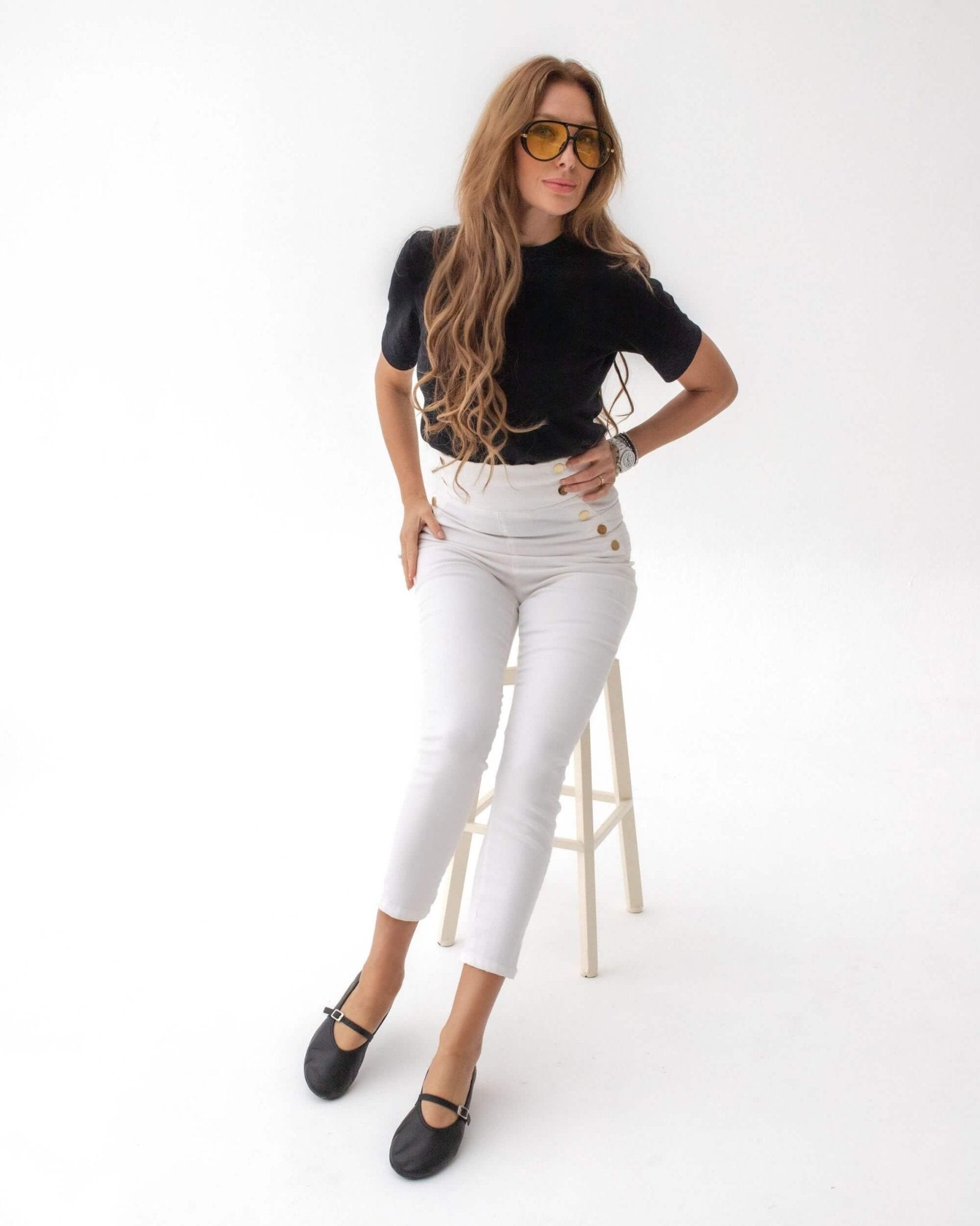 Handmade black nappa leather Mary Jane flats styled with white high-waisted trousers and black top — full-length studio | Mary Jane in Midnight by Shoeq