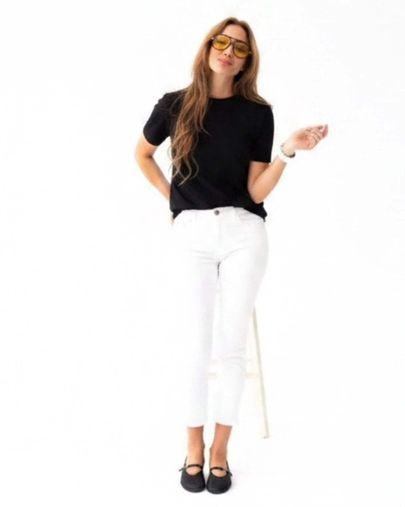 Handmade black nappa leather Mary Jane shoes with ankle strap styled with white cropped trousers and black top — full-length | Mary Jane in Midnight by Shoeq
