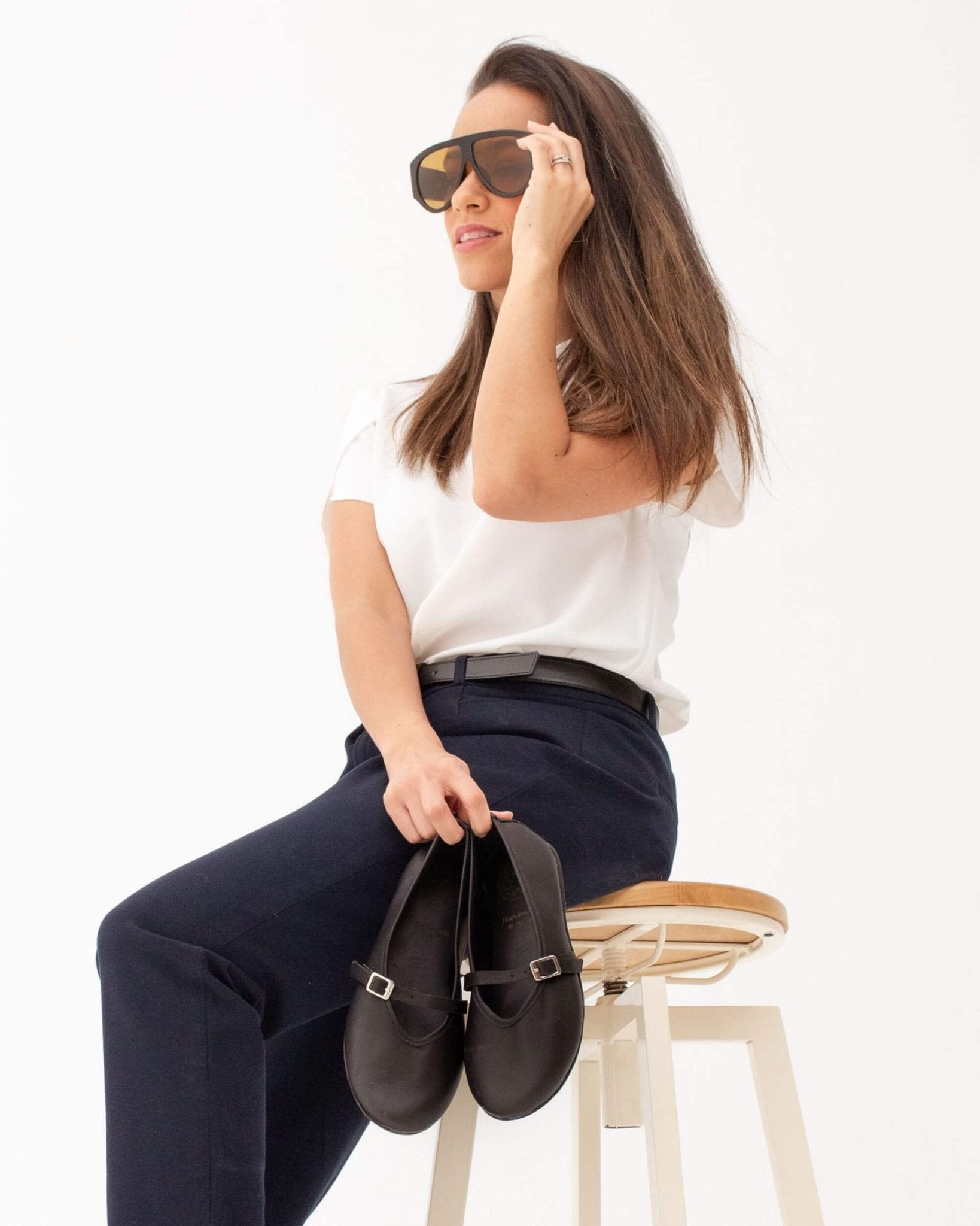 Black nappa leather Mary Jane shoes held showing ankle strap with silver buckle and flat sole — handmade in Menorca, Spain | Mary Jane in Midnight by Shoeq