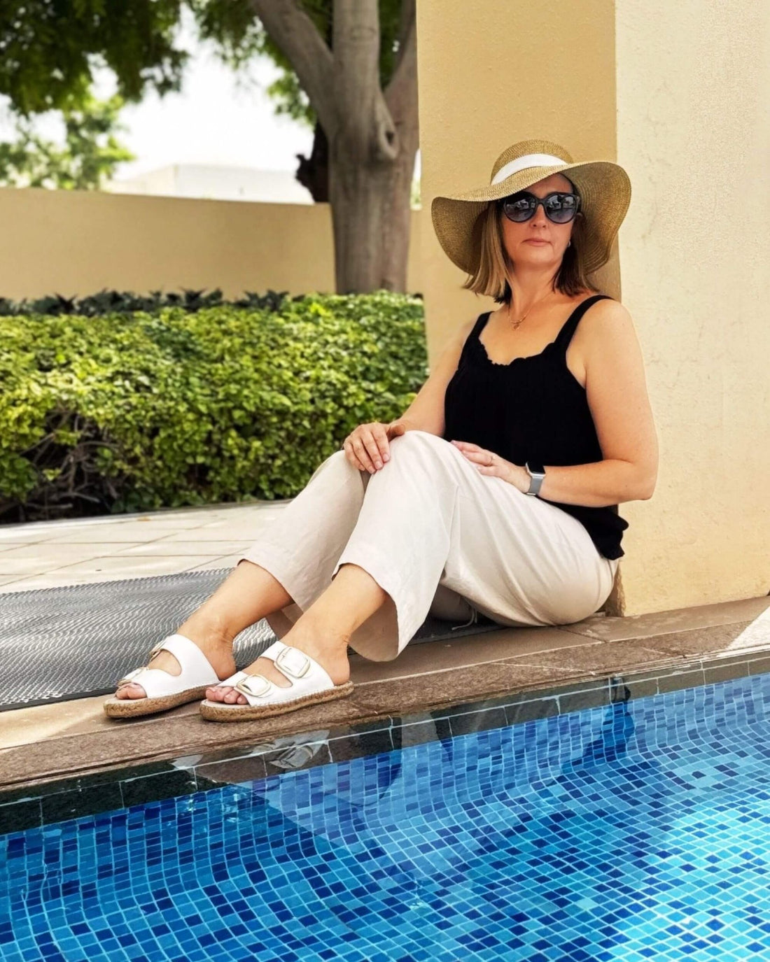 Urban Espadrille Slide in White — overhead shot of white leather slides with gold double buckles on grey background | Shoeq